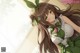 Anime girl with long brown hair wearing a green dress.